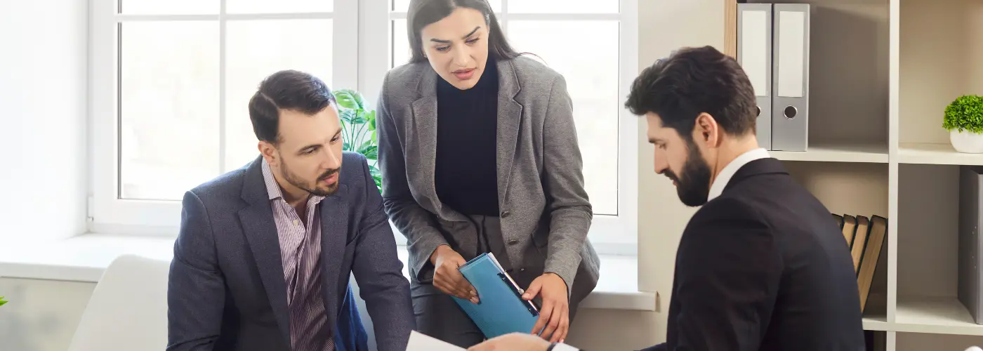Sales professional listening carefully while a prospect explains their challenges during a meeting