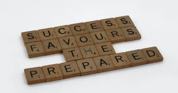 Wooden letter tiles spelling a message about preparation and success.