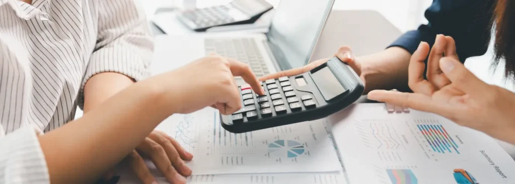 Business professionals reviewing financial data to assess pain impact selling of unresolved problems.