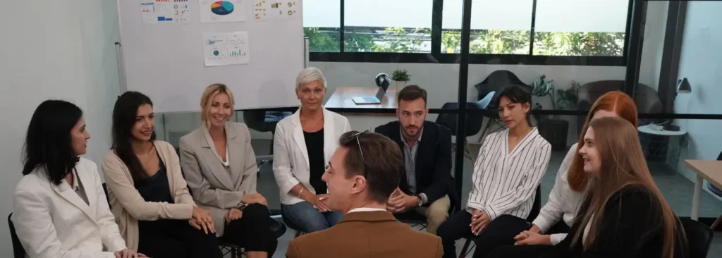 Business leader facilitating a discussion focused on business challenges and decisions.