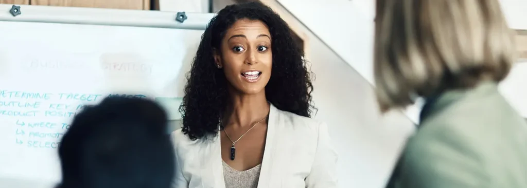 Sales coach explaining effective listening techniques to a team