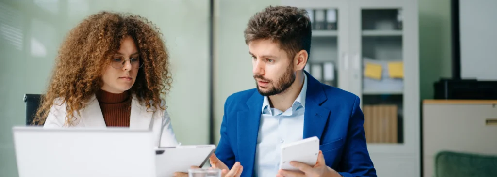 Two business professionals discussing outsourced sales in Ireland and options